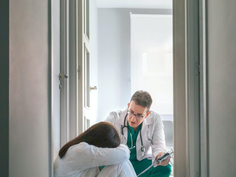 psychiatrist-talking-to-patient-sitting-on-the-floor-in-a-mental-health-center